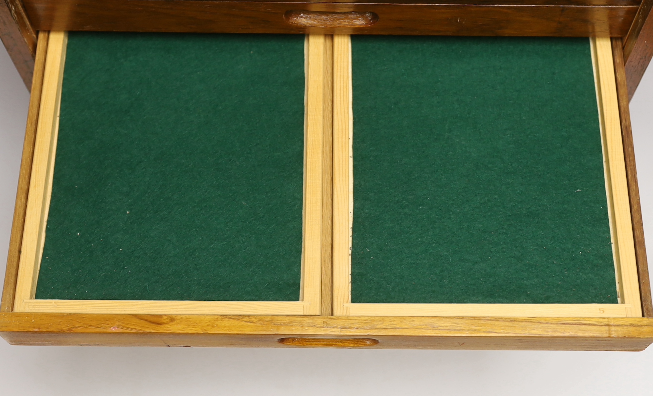 A twelve drawer mahogany collector’s cabinet with unusual sliding front cover, each shallow drawer containing two additional felt lined removable trays, possibly suitable for a coin collection, watch parts, etc. 55cm hig